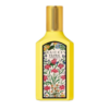 gucci flora gorgeous orchid eau de perfume in a bright yellow bottle with a floral patterned label